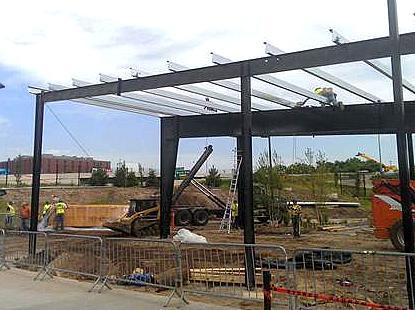 Workers installing a solar array at CHS Field in St. Paul