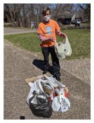 photo of person collecting trash on Earth Day 2020