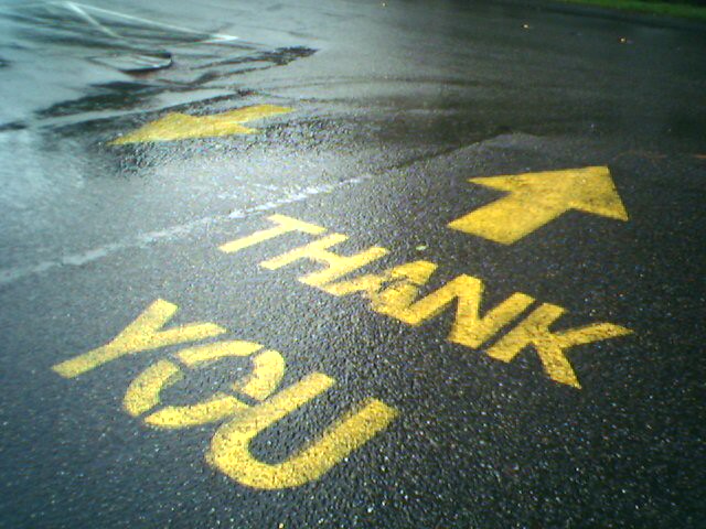 Thank you with an arrow on the street