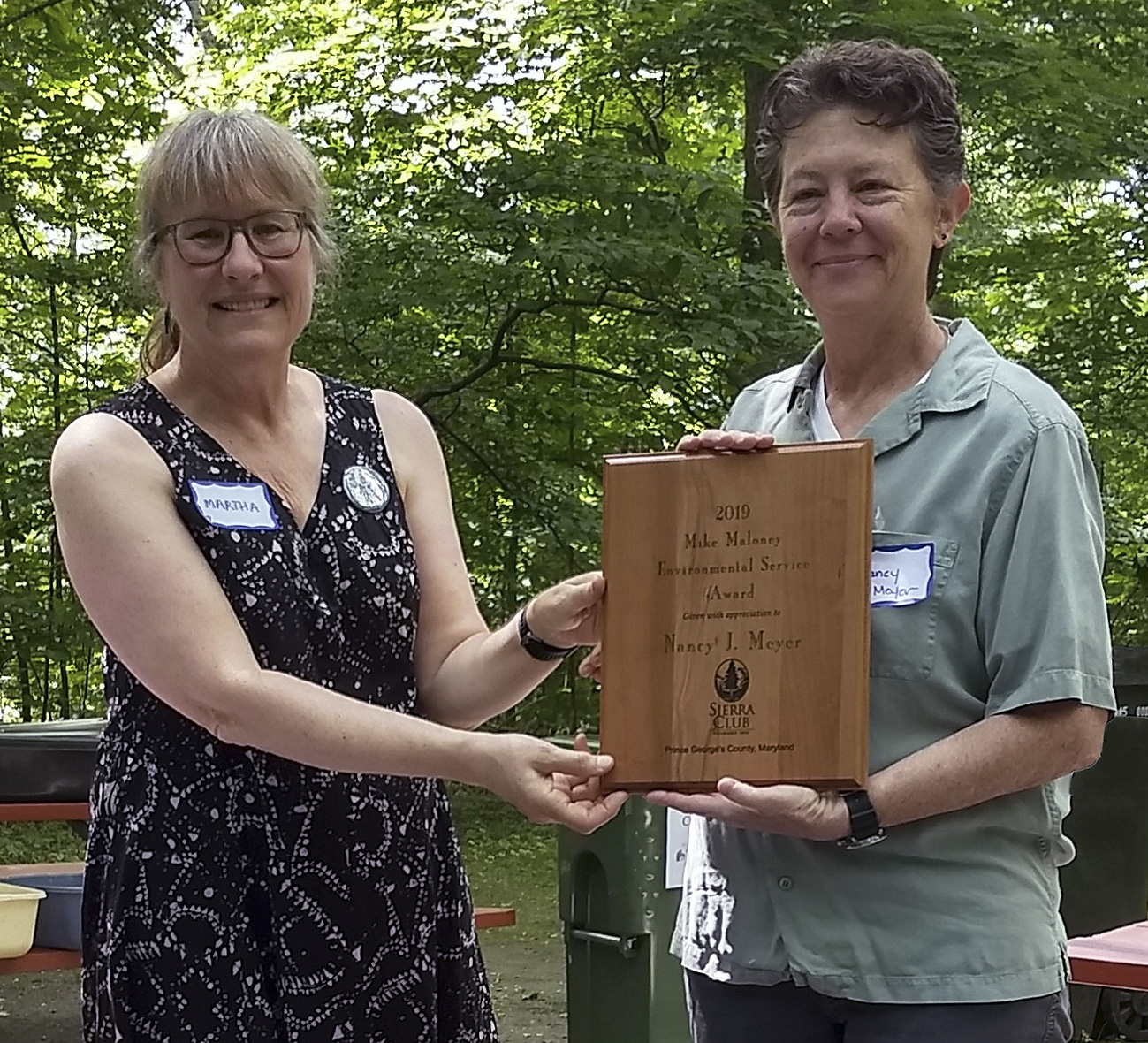 Martha Ainsworth awards Environmental Service Award to Nancy J. Meyer.