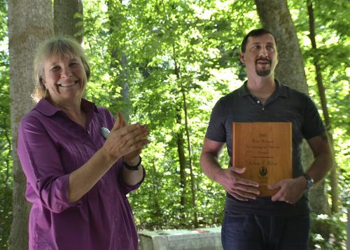 Martha Ainsworth presents award to Adam C. Ortiz