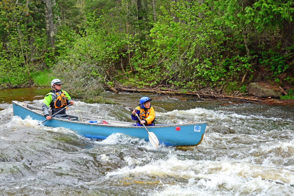 Tandem canoeists navigate Mays Ledges on the Bois Brule River