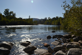 View of river canyon from river level, looking upstream into the sun