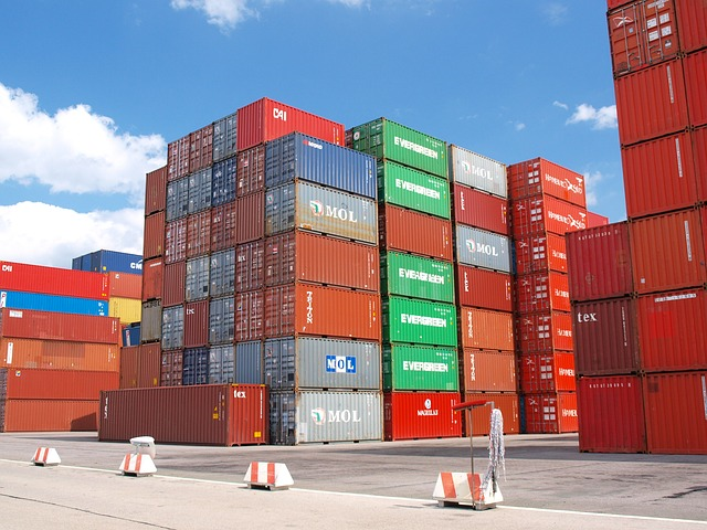 Colorful freight containers stacked in port on a sunny day