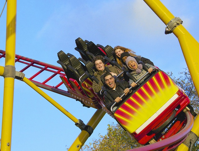 Colorful roller coaster full of people
