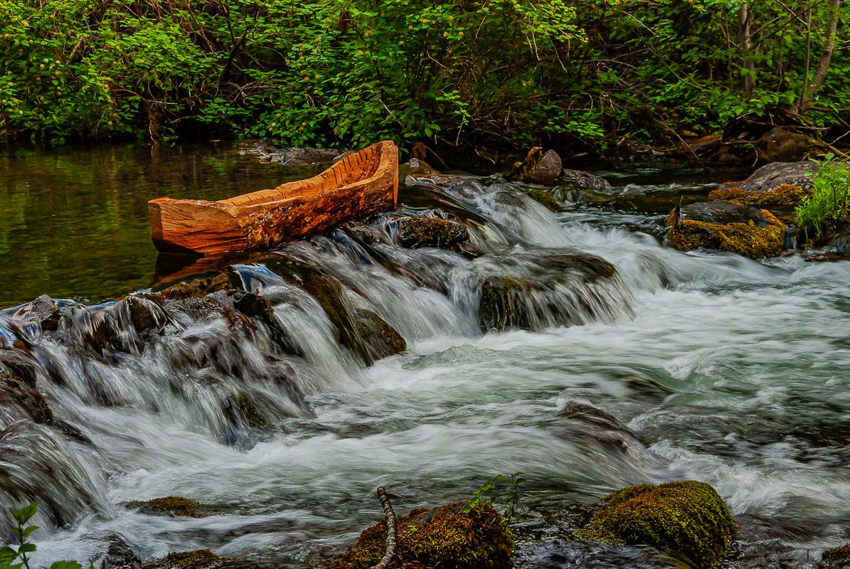 Carved log canoe
