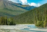 Three people on a river in the backcountry of Alaska