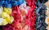 Fashion flowers of a collection lie in a cardboard box in the warehouse of the Steyer artificial flower manufactory. 
