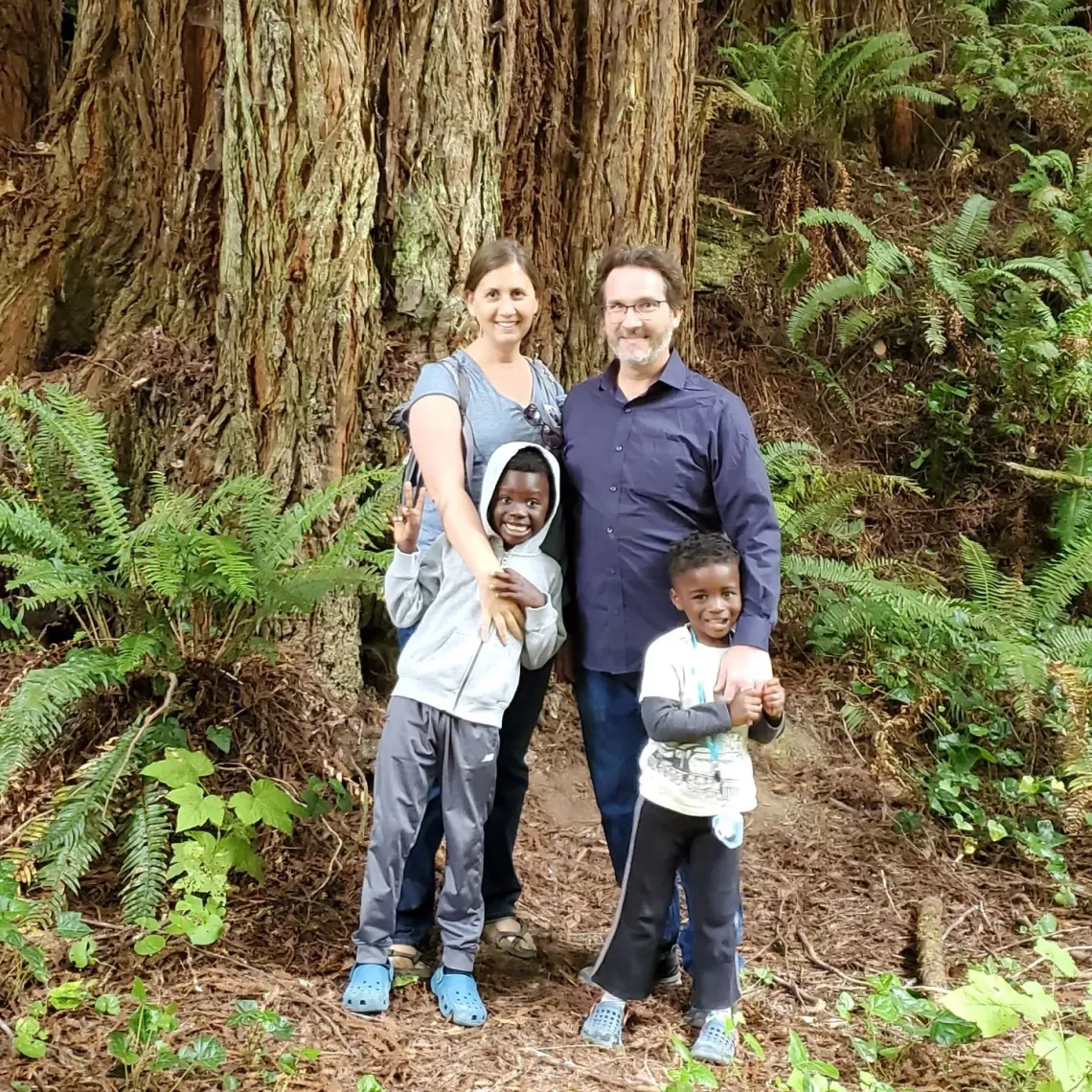 Jackie Ostfeld and Kyle Ash on a hike with their children in the redwood forests of Mendocino County.