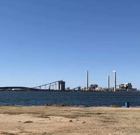 The Spruce coal plant sits behind Calaveras Lake in San Antonio.