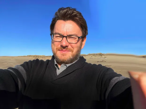 Mark Van Landuyt against a blue sky background