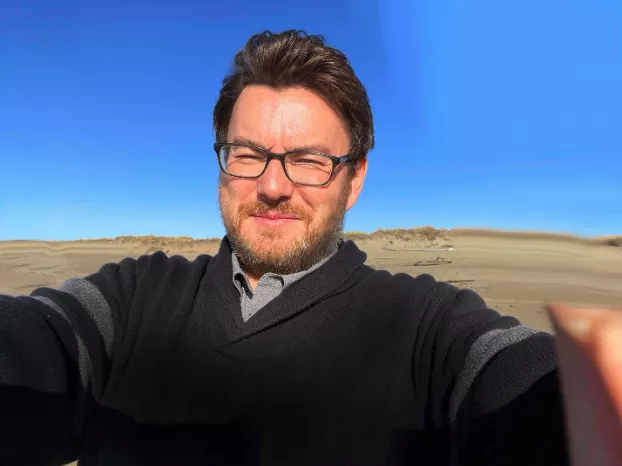 Mark Van Landuyt against a blue sky background