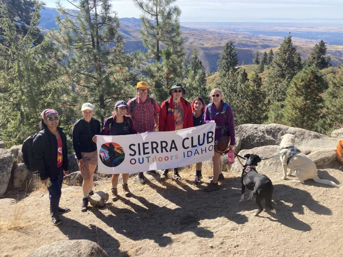 hikers holding a banner that says Sierra Club OUTdoors Idaho