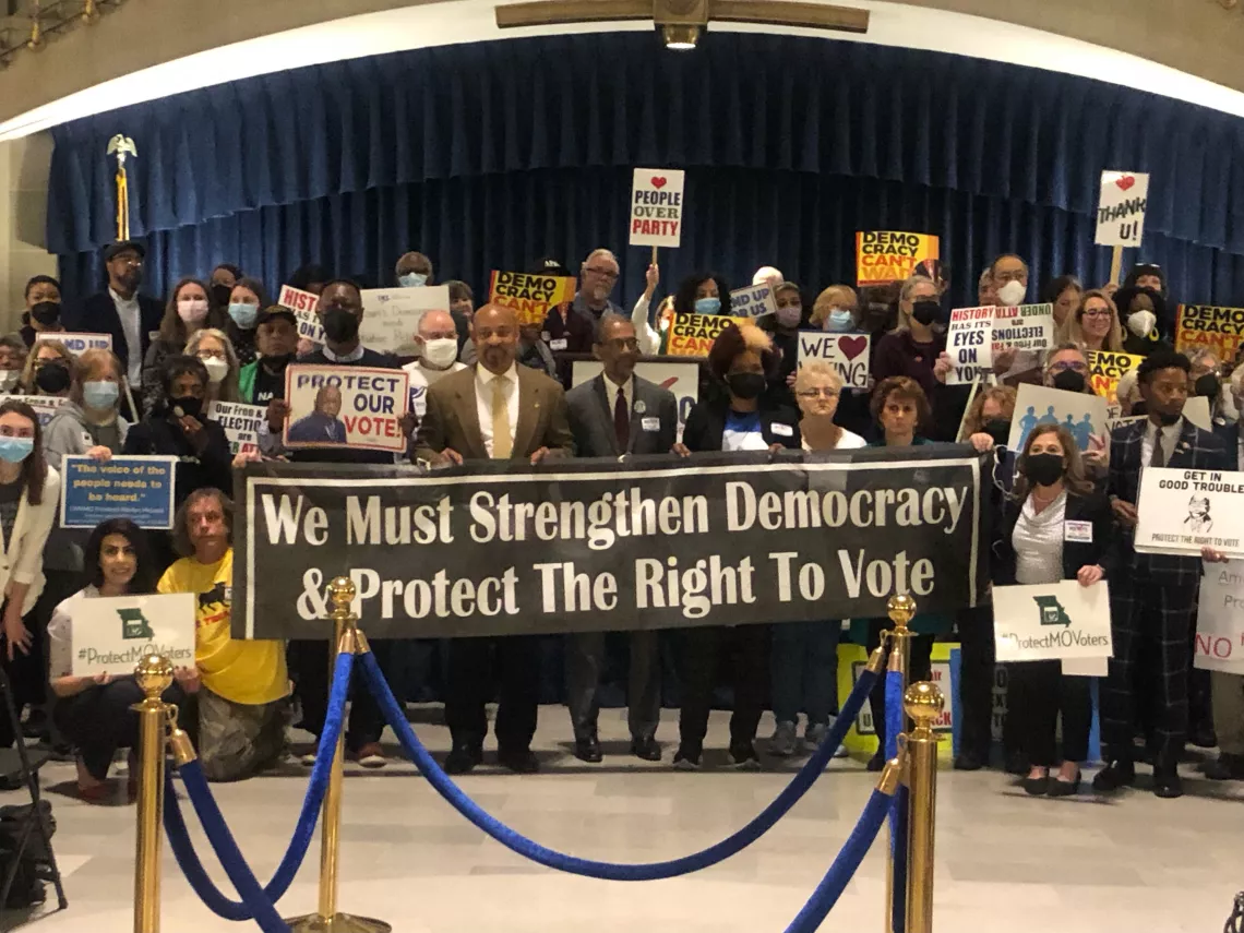 Activists holding signs at Lobby Day