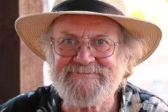 Glenn Kirby smiles wearing a hat
