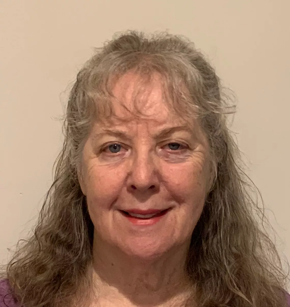 Pamela Meigs headshot, smiling against a white background