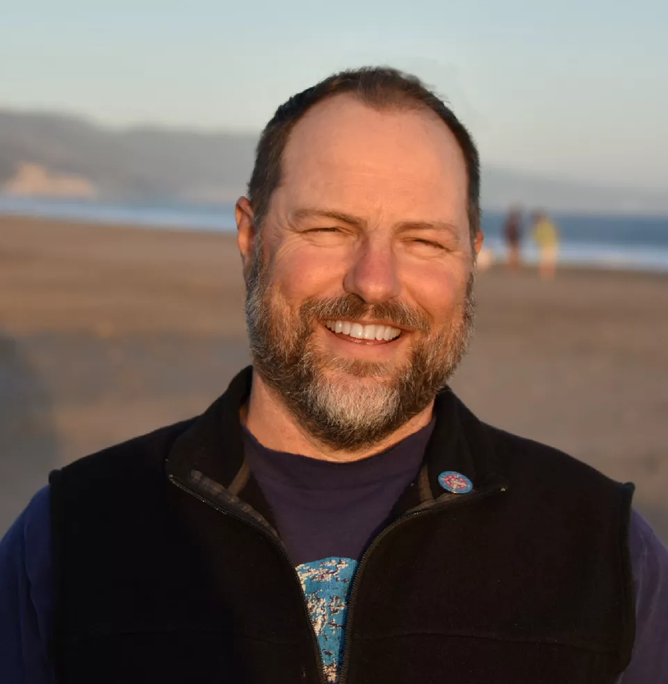 Matt Turner smiles on beach background