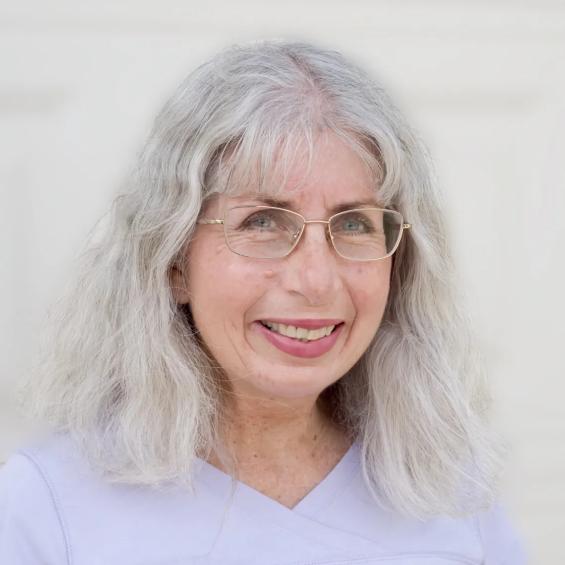 Carol Silva smiles on a white background