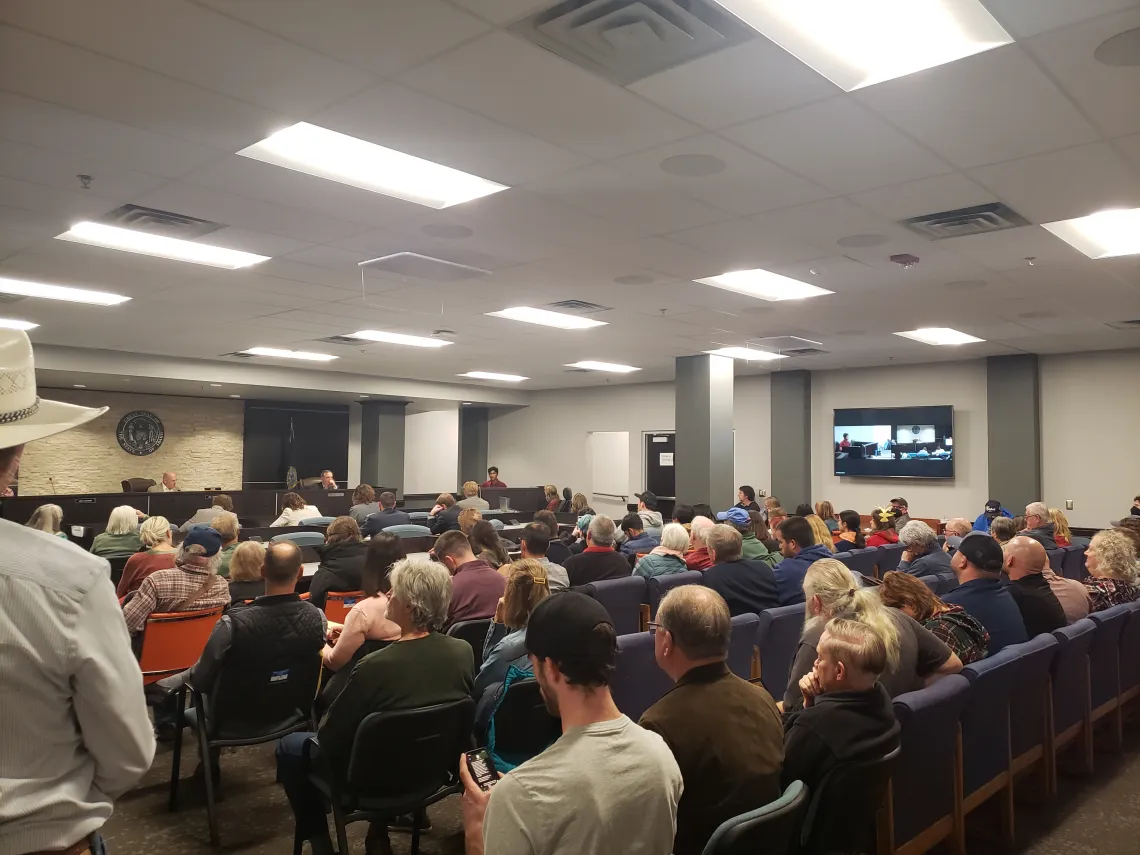 Picture of dozens of people sitting in a hearing room