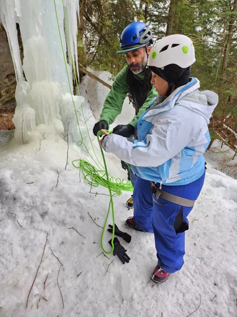 Dom Mullins assists Lorena Aguayo Marquez with her harness.