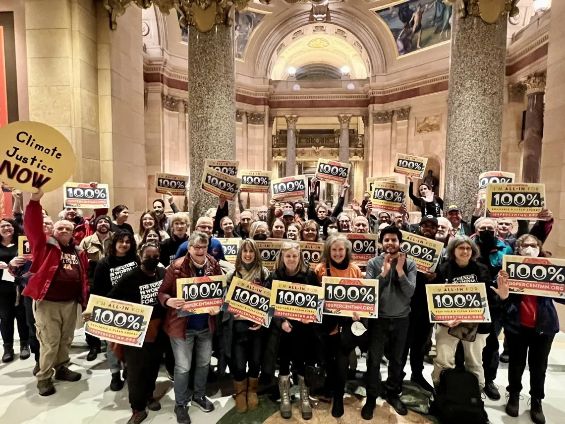 Activists celebrate the passage of 100% Clean Energy bill inside the Minnesota Capitol