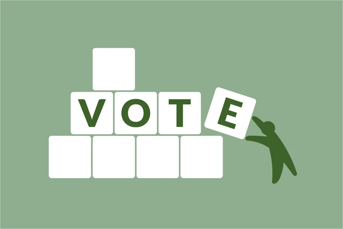 "VOTE" spelled out in blocks, being built by a small green figure.