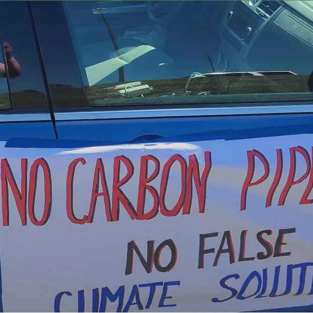 Photo of "No Carbon Pipelines" sign on the side of a car. Credit: Iowa Sierra Club