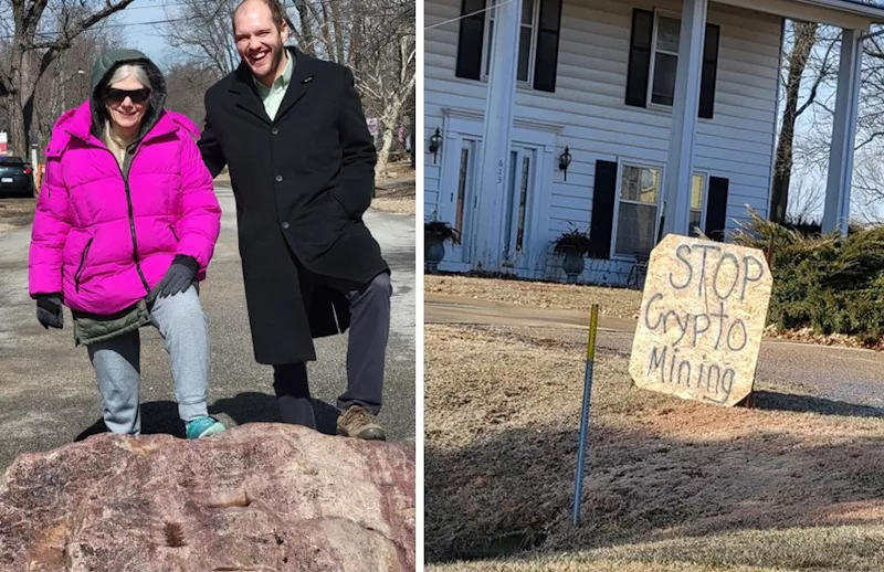 Man and woman on McClouth rock in the road, stop cryptomining protest sign in front of house