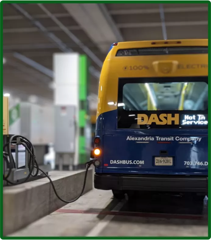 Electric bus being charged in a parking garage