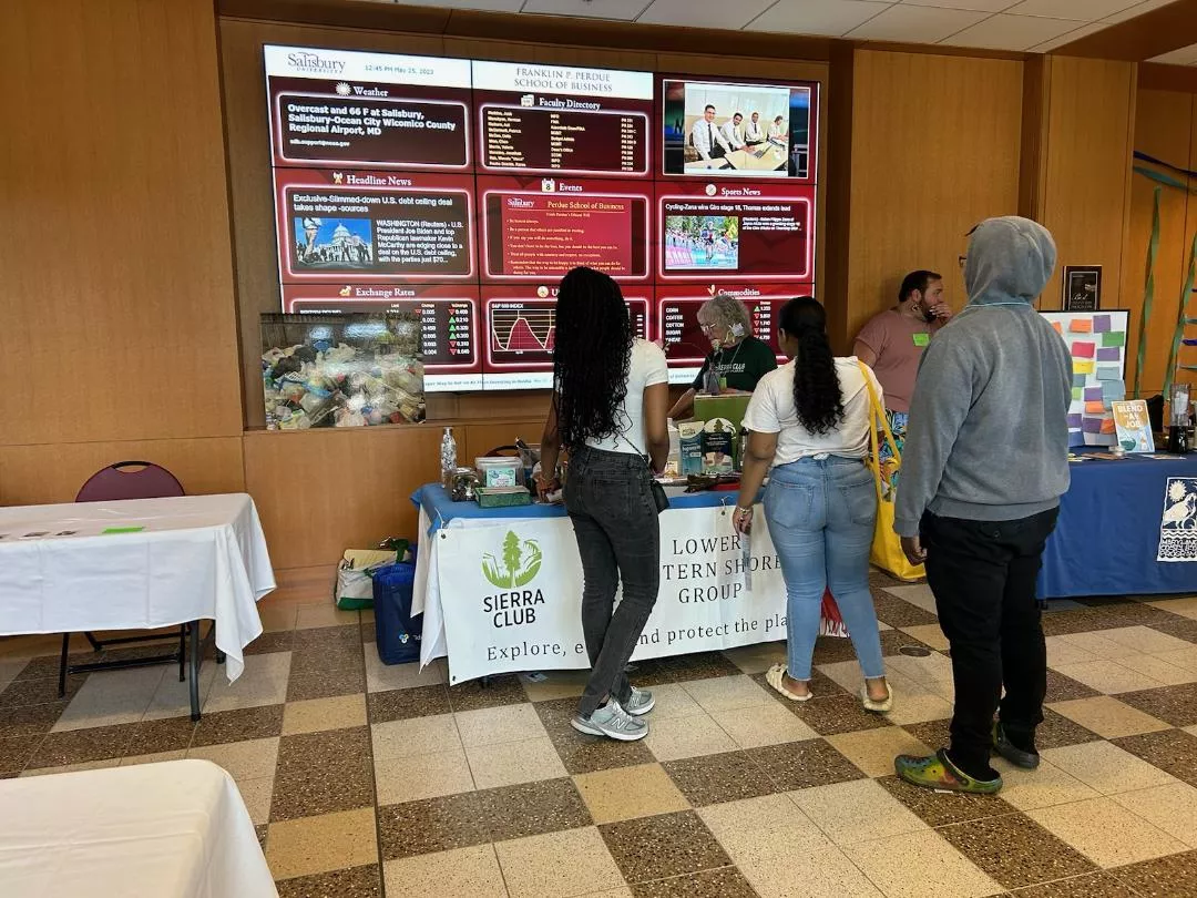 Students at the Youth Environmental Action Summit check out the Sierra Club table