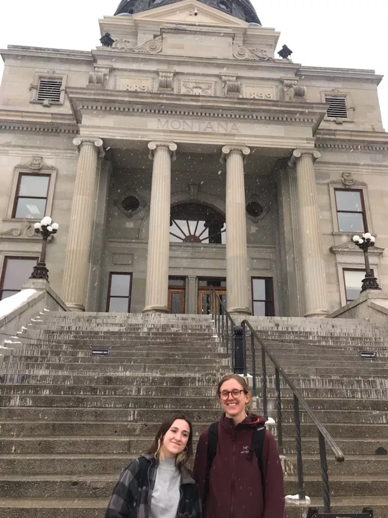 Two people stand in front of the Montana State Capitol