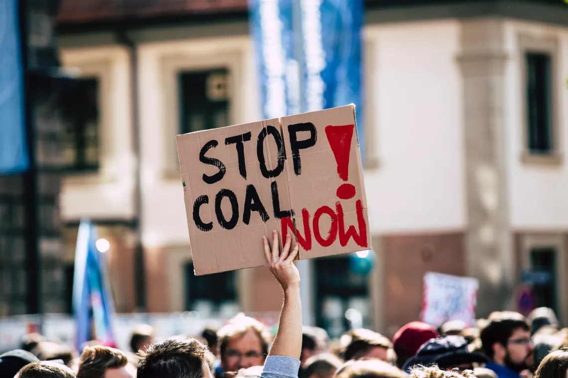 protesters with stop coal now sign