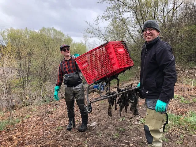 Volunteers remove shopping cart 