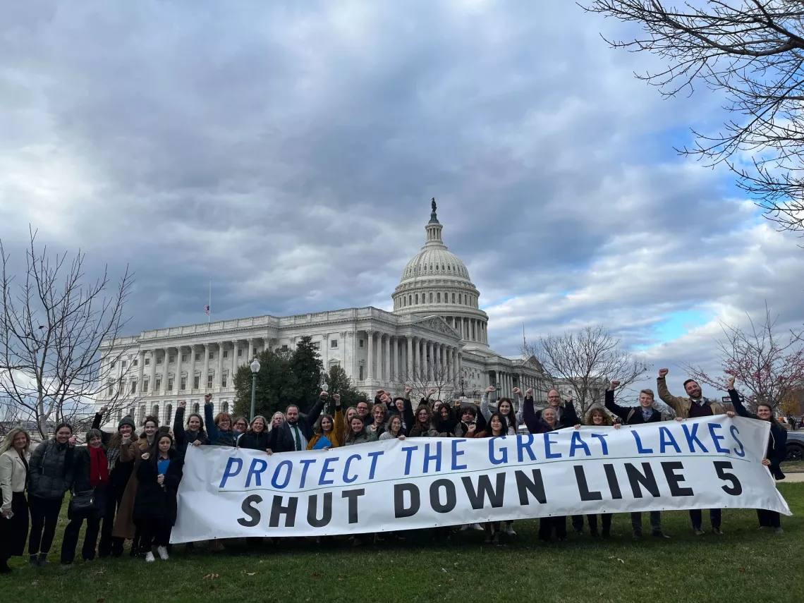 photo of environmental advocates with banner "Protect the Great Lakes Shut Down Line 5" in front of DC Capitol