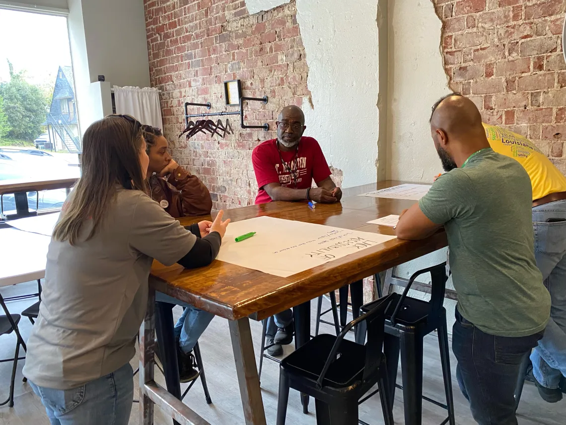 Senior Campaign Strategist Lornett Vestal facilitates a conversation at a table of three participating veterans at the Augusta stop of the Sierra Club Military Outdoors listening session series.