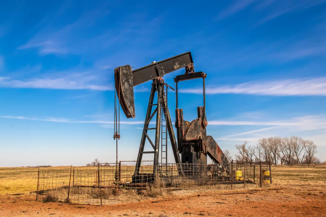 A oil rig in a field.