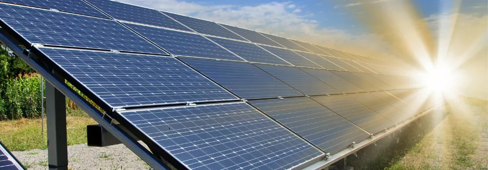 photo of solar panels with sun rays
