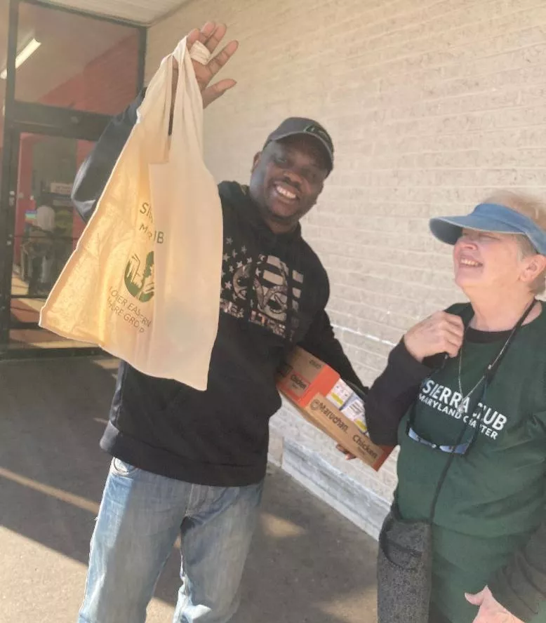 Distributing free reusable tote bags outside grocery store in Salisbury, MD
