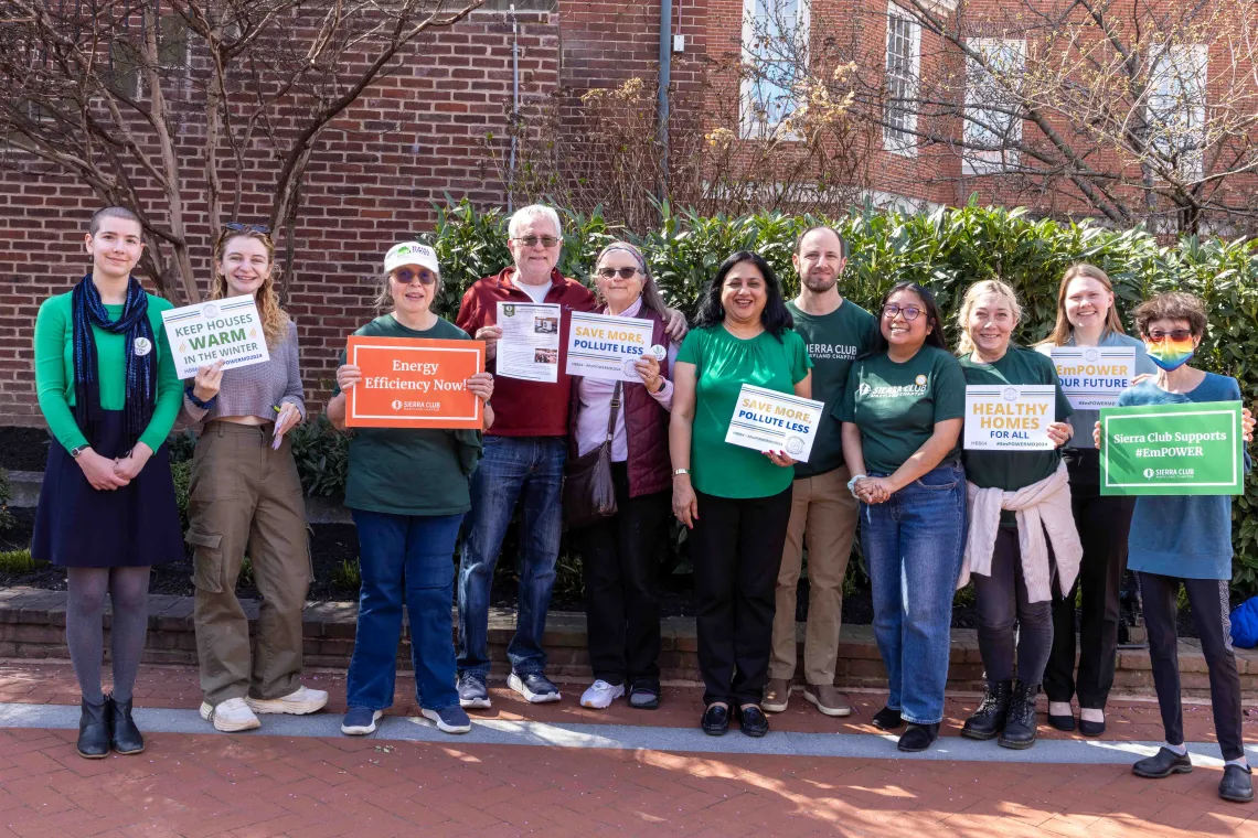 Sierra Club Volunteers and Staff in Annapolis on a sunny day, holding signs supporting EmPOWER.