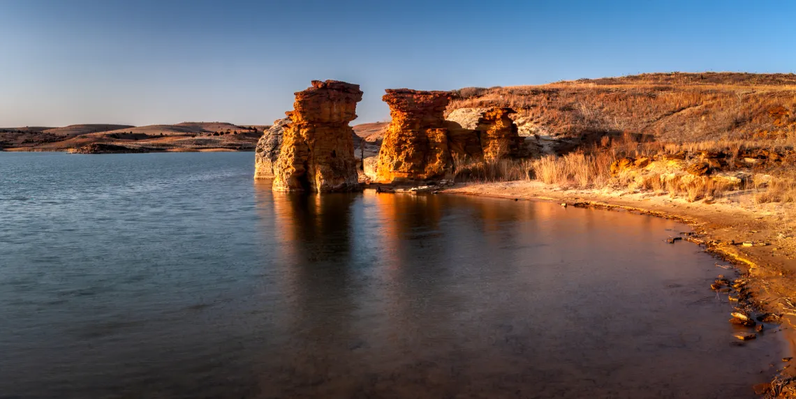 blue lake and sky surrounded by big rock formations