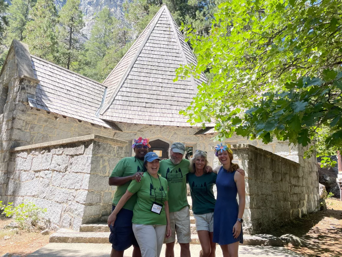 Five volunteer docents pose in front of the Yosemite Conservation Heritage Center