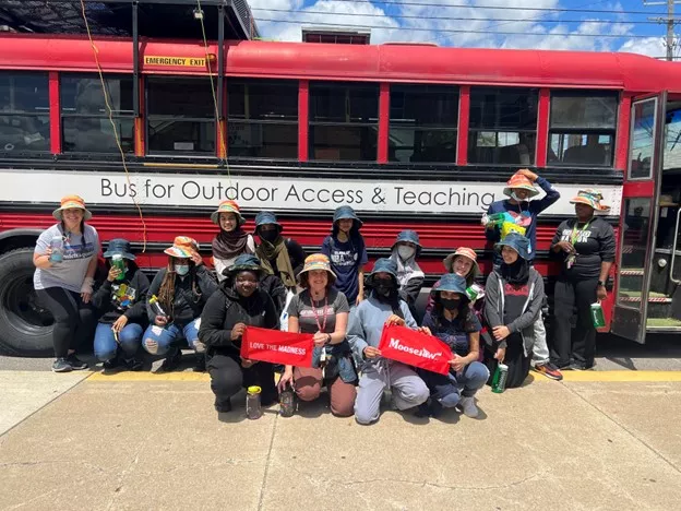 Students pose in from of BOAT bus
