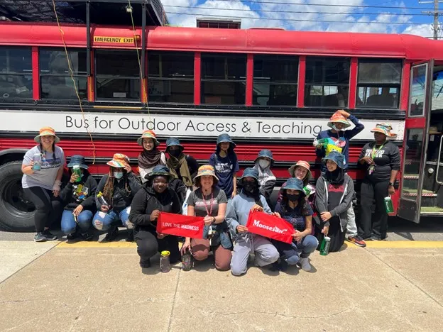 Students pose in from of BOAT bus