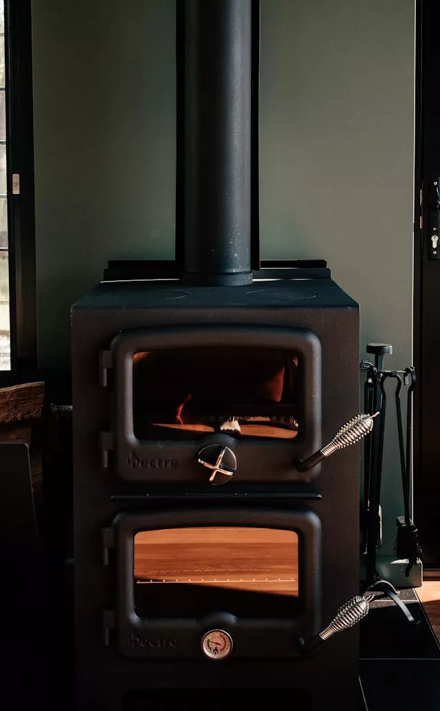 Wood stove. Photo by Rachel Claire: https://www.pexels.com/photo/photo-of-a-fireplace-8112294/