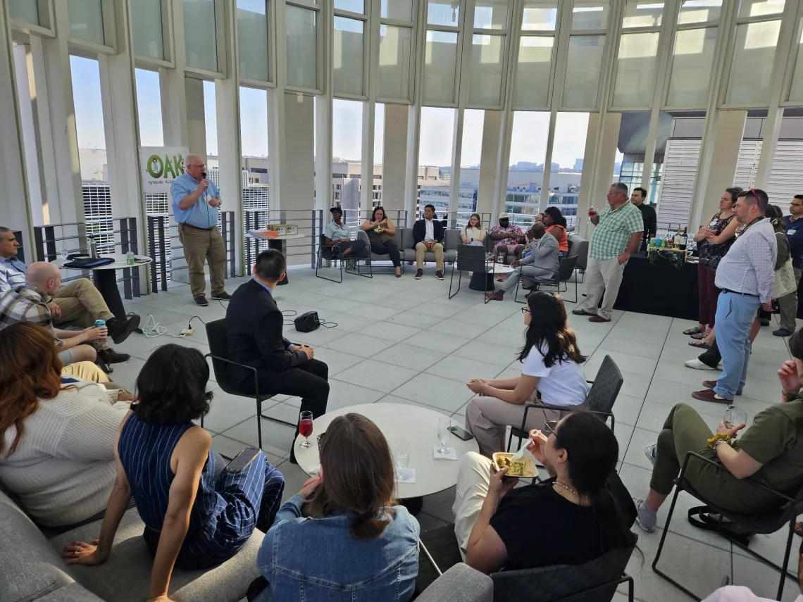 A group of people gather to listen to a speaker