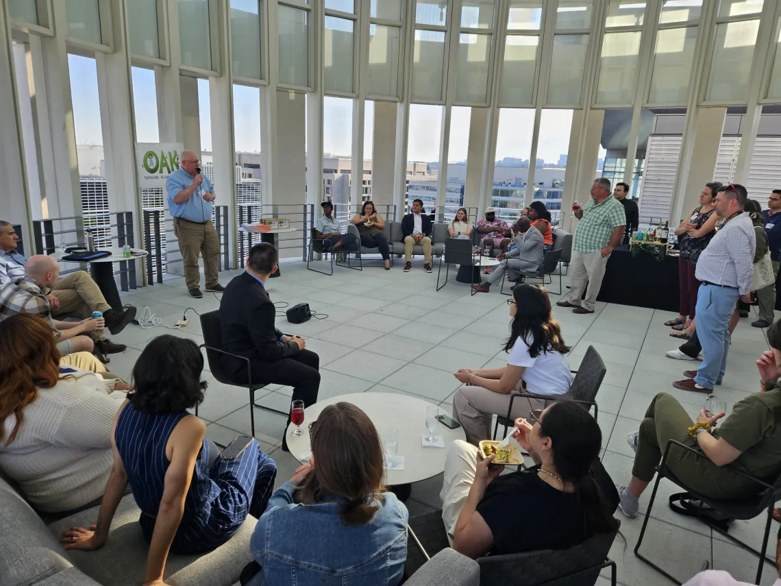 A group of people gather to listen to a speaker
