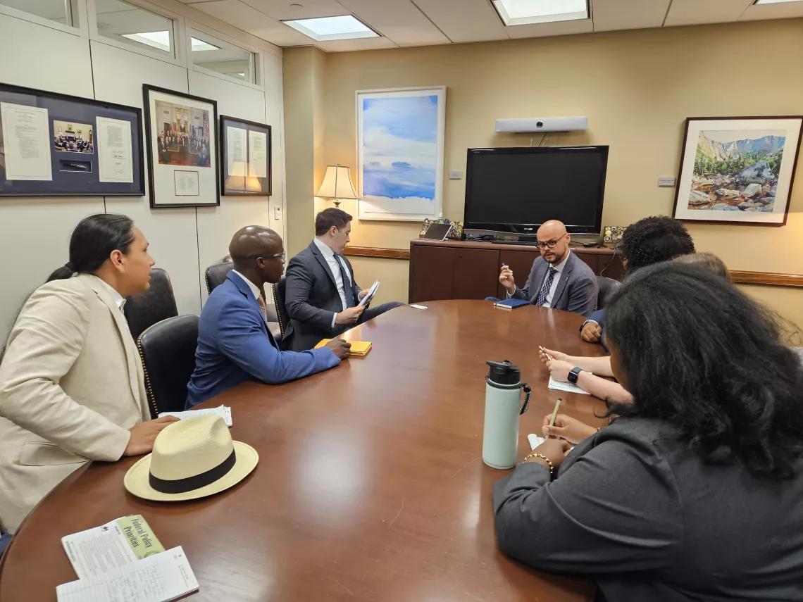 A group of people sit around a table