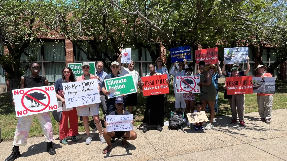 16 Hartford Community Members Rally with Signs Outside Capitol Area System