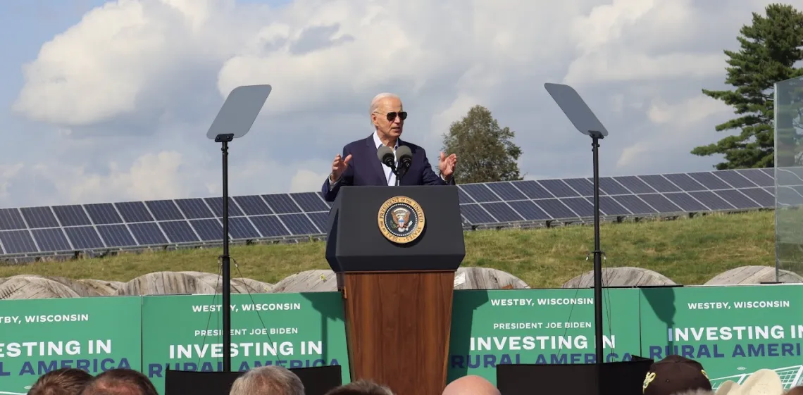 President Joe Biden standing in front of solar panels in Westby, WI