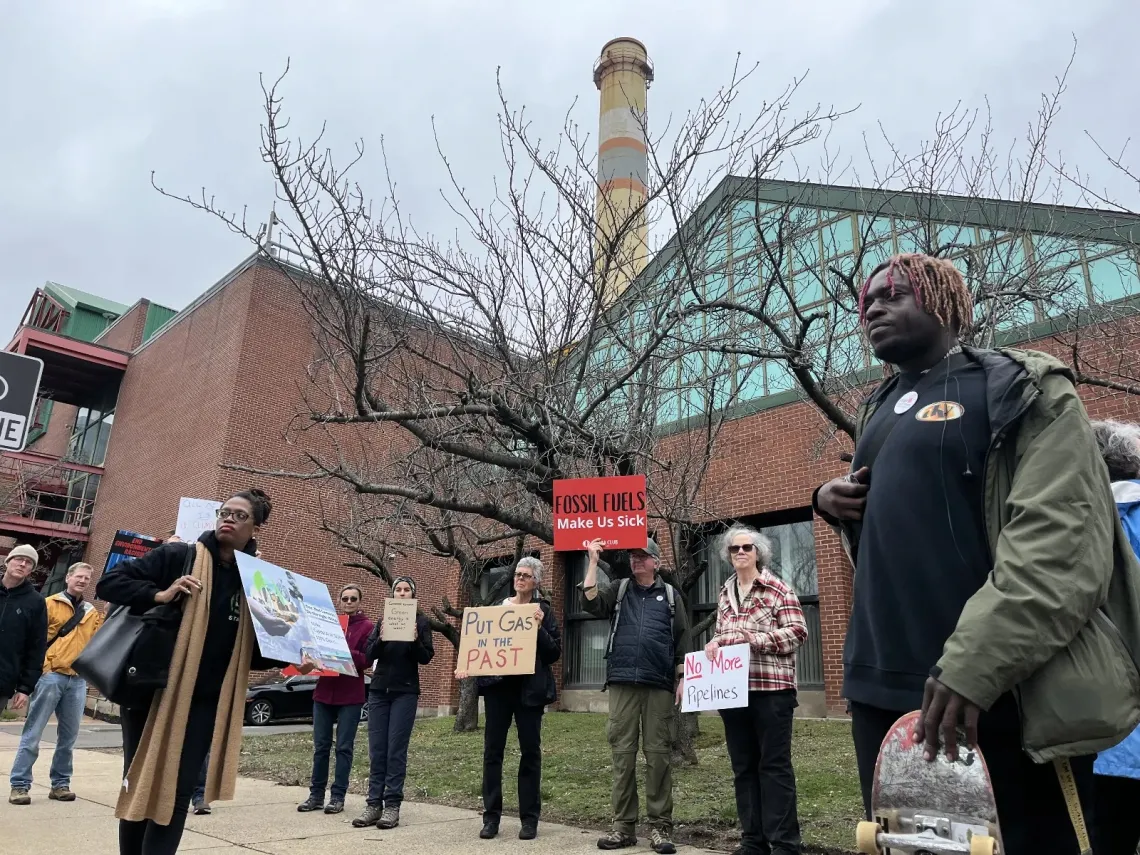 People gather for rally with signs outside Capitol Area System